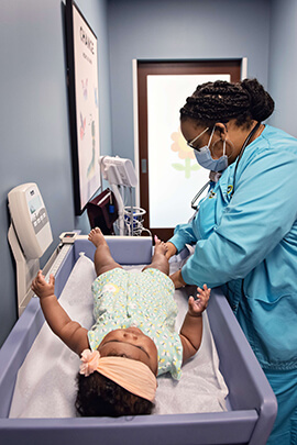 nurse looking over baby