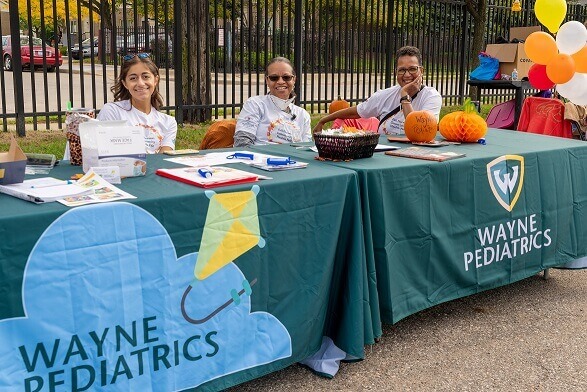 wayne-peds-tables-6167372829472 staff at outdoor event